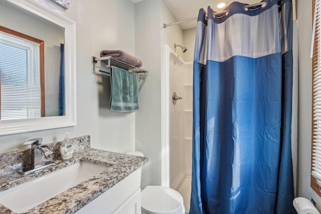 bathroom featuring vanity, toilet, and a shower with shower curtain