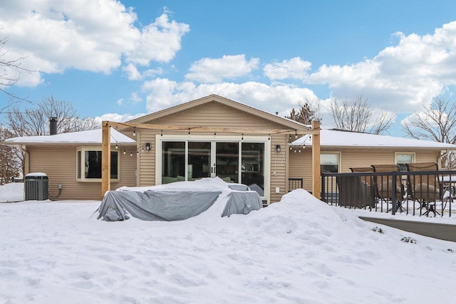 snow covered house with central AC