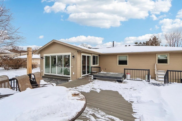 snow covered property with a deck