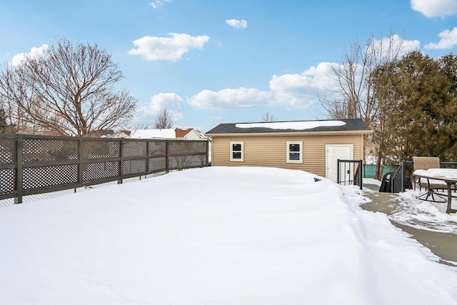 yard covered in snow featuring a fenced backyard