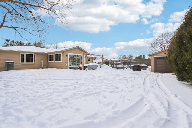 exterior space with an outbuilding, central AC unit, and a garage