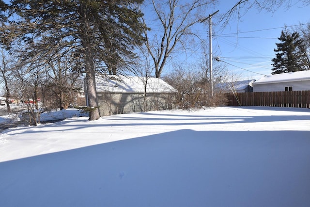 snowy yard with fence