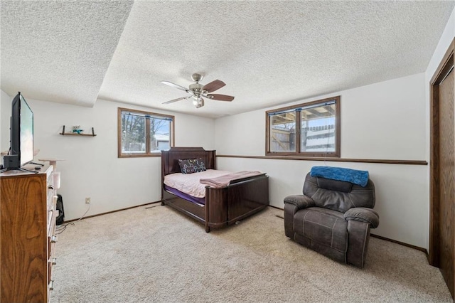 bedroom with light carpet, ceiling fan, and baseboards