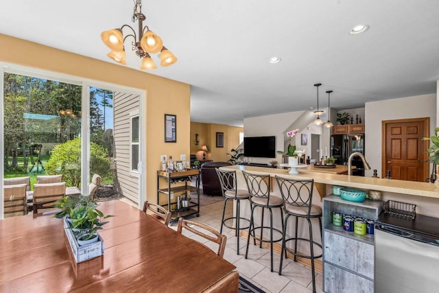 dining space with light tile patterned floors, recessed lighting, and an inviting chandelier