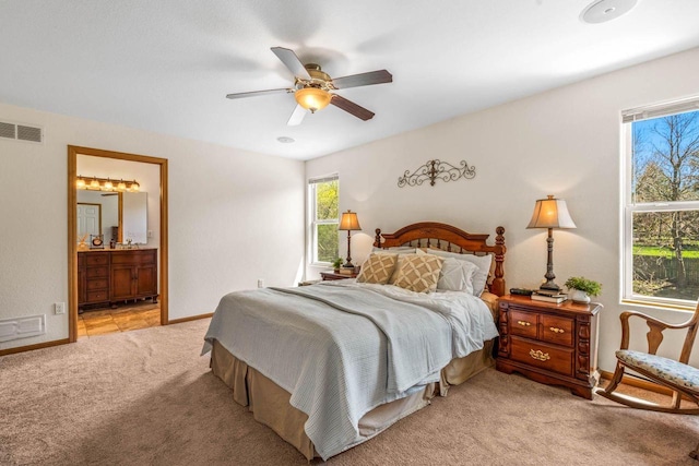 bedroom featuring baseboards, visible vents, a ceiling fan, connected bathroom, and light colored carpet