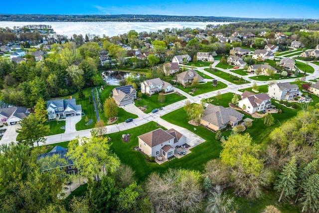 birds eye view of property with a water view and a residential view