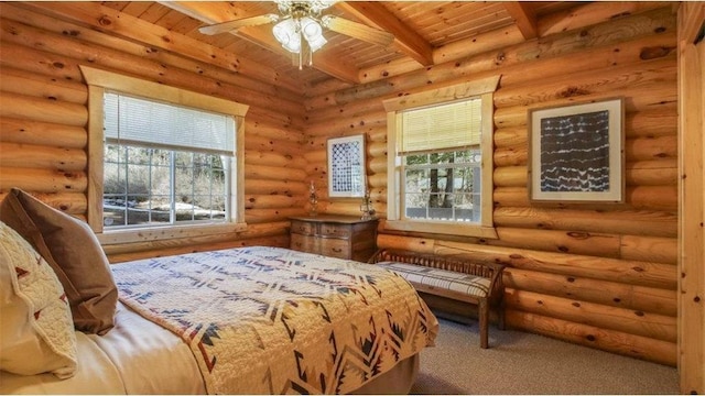 bedroom featuring rustic walls, beamed ceiling, multiple windows, and wood ceiling