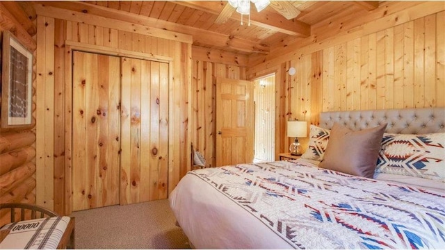 bedroom with carpet, beam ceiling, wood ceiling, and wood walls