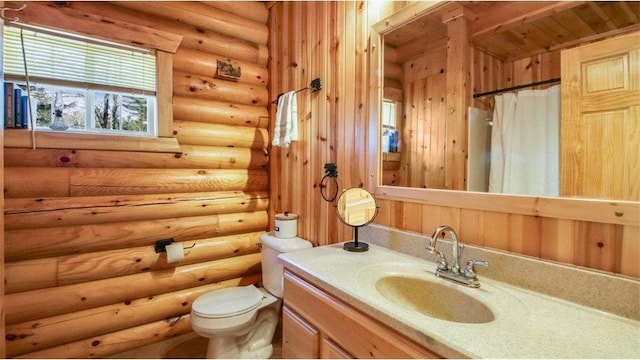 full bathroom with vanity, a shower with shower curtain, toilet, and log walls