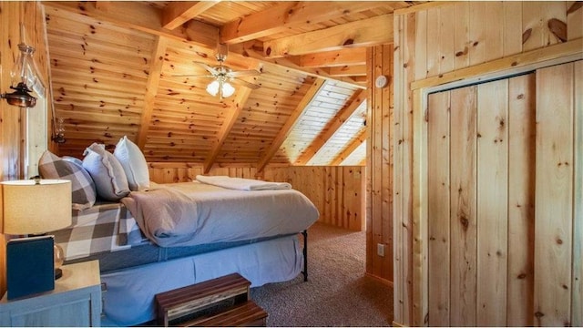 bedroom with lofted ceiling with beams, wooden walls, carpet flooring, and wood ceiling