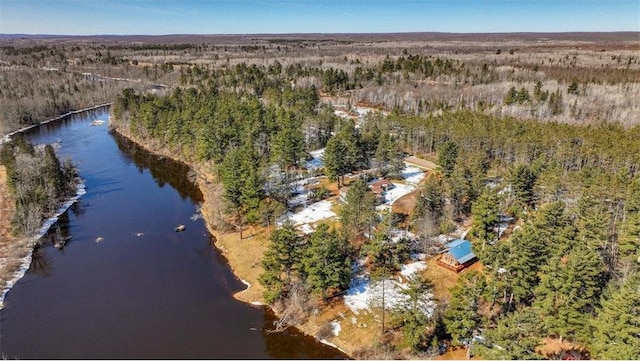 aerial view featuring a forest view and a water view