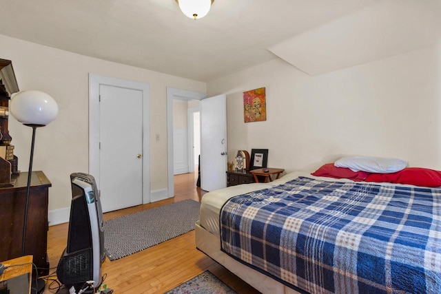 bedroom featuring light wood-style flooring and baseboards