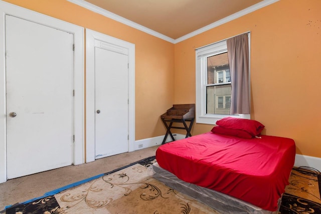 bedroom featuring ornamental molding, carpet, and baseboards