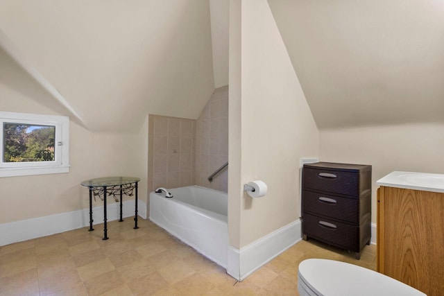 full bathroom with lofted ceiling, toilet, vanity, baseboards, and a bath