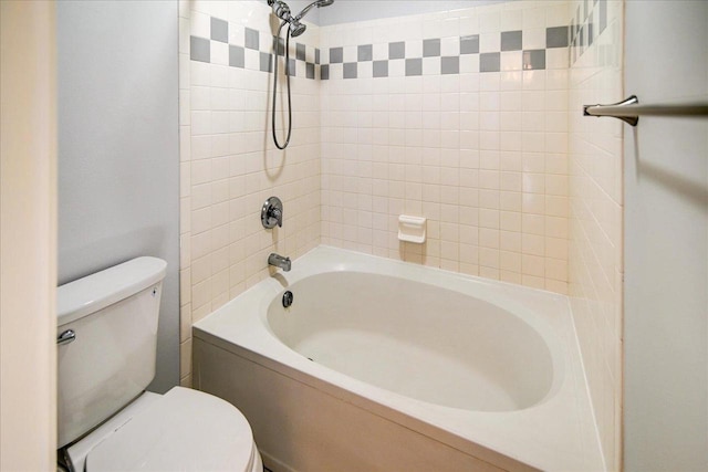 bathroom with bathtub / shower combination and toilet