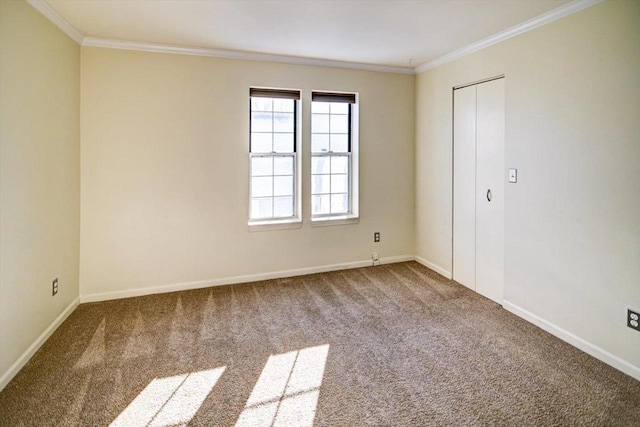 carpeted empty room featuring baseboards and ornamental molding