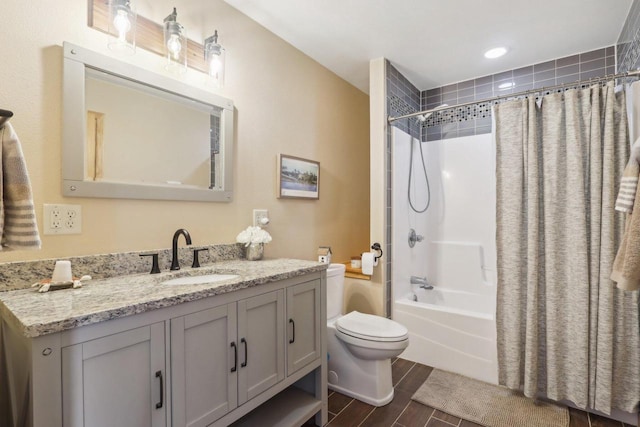 bathroom featuring wood tiled floor, shower / tub combo with curtain, vanity, and toilet