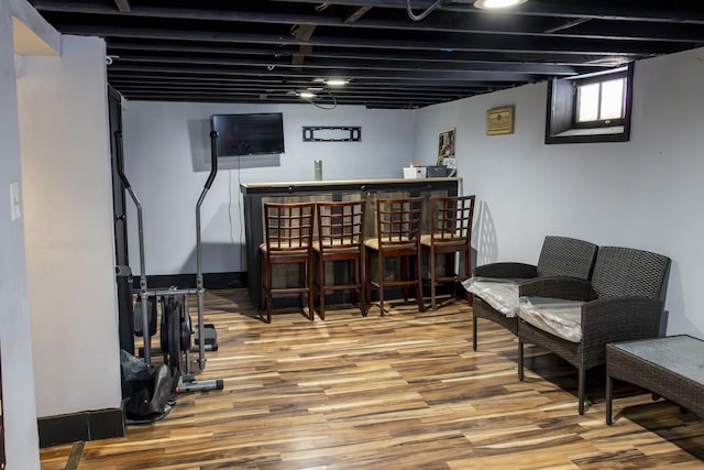 interior space with a dry bar and wood finished floors