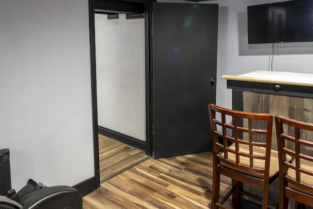 bar with wood finished floors and baseboards