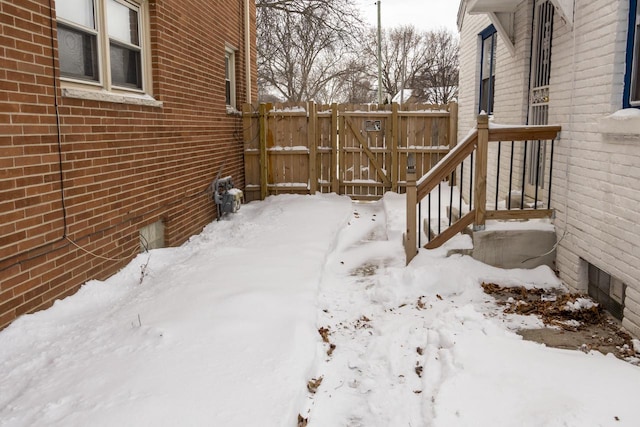 snowy yard with fence