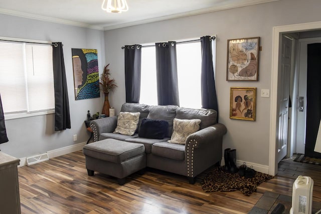 living room with dark wood-style floors, baseboards, visible vents, and crown molding