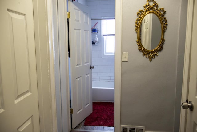 corridor with visible vents and a textured wall