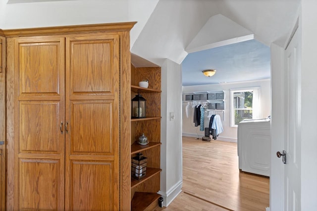 hallway with light wood finished floors and baseboards