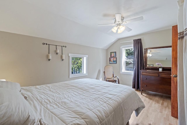 bedroom featuring lofted ceiling, light wood-style flooring, and ceiling fan