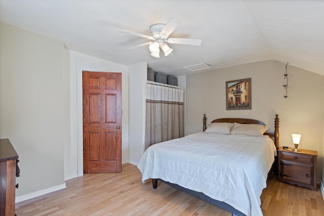 bedroom featuring lofted ceiling, ceiling fan, light wood-style flooring, and baseboards