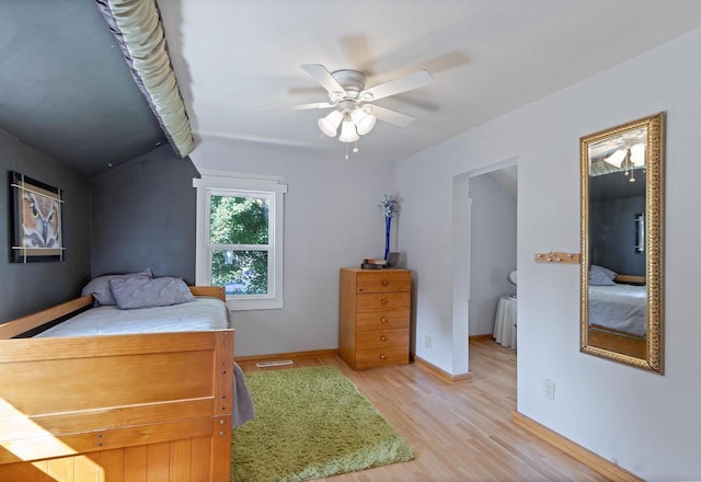 bedroom with baseboards, a ceiling fan, visible vents, and light wood-style floors