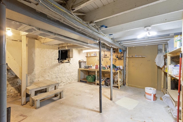 unfinished basement with a workshop area