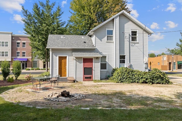 view of front of house featuring entry steps and a shingled roof