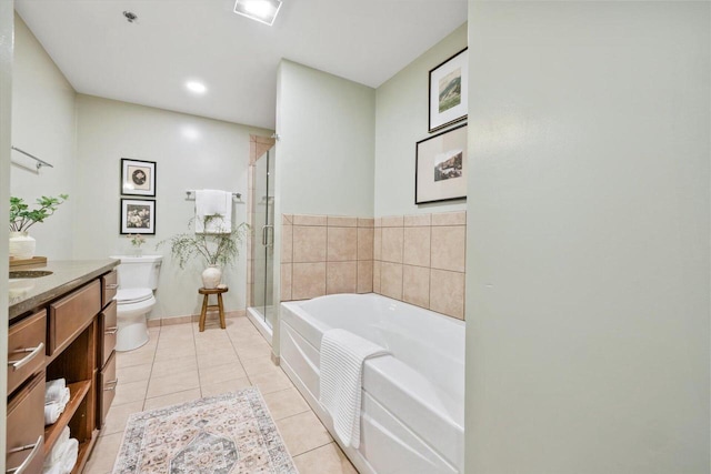 bathroom featuring a garden tub, toilet, a stall shower, vanity, and tile patterned floors