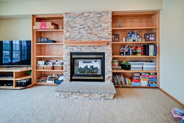 carpeted living area with a fireplace and baseboards