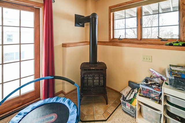 interior details featuring a wood stove and baseboards