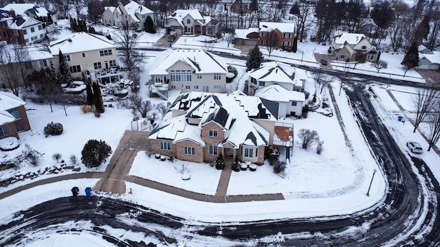 snowy aerial view with a residential view