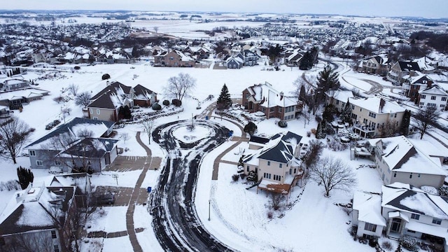 snowy aerial view featuring a residential view