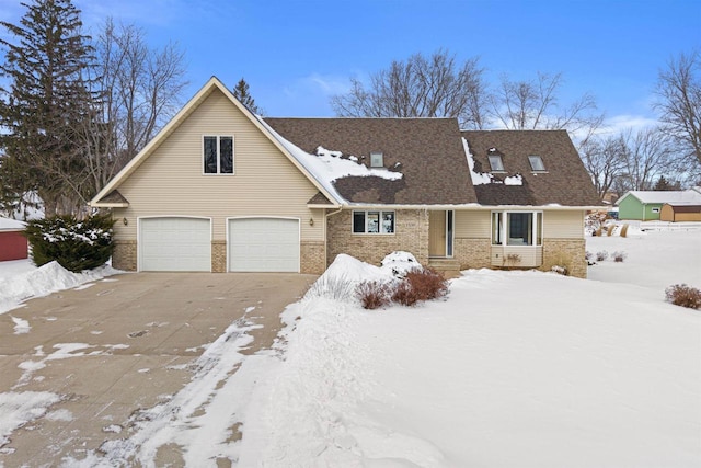 view of front facade featuring an attached garage, concrete driveway, and brick siding