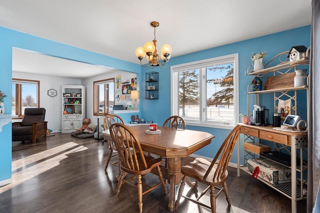 dining room with baseboards, dark wood-type flooring, and a notable chandelier