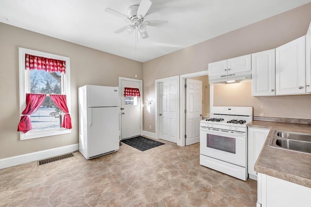 kitchen featuring visible vents, white cabinetry, a sink, white appliances, and under cabinet range hood