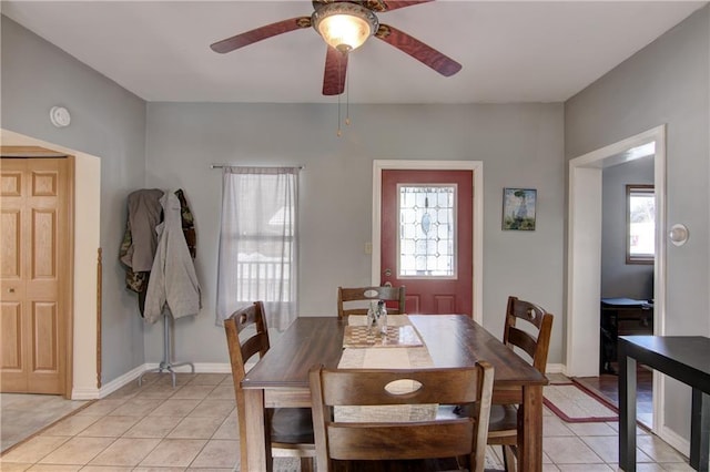 dining area with light tile patterned flooring, plenty of natural light, and baseboards