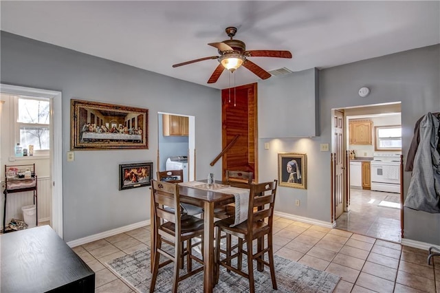 dining room featuring baseboards, visible vents, ceiling fan, and light tile patterned flooring