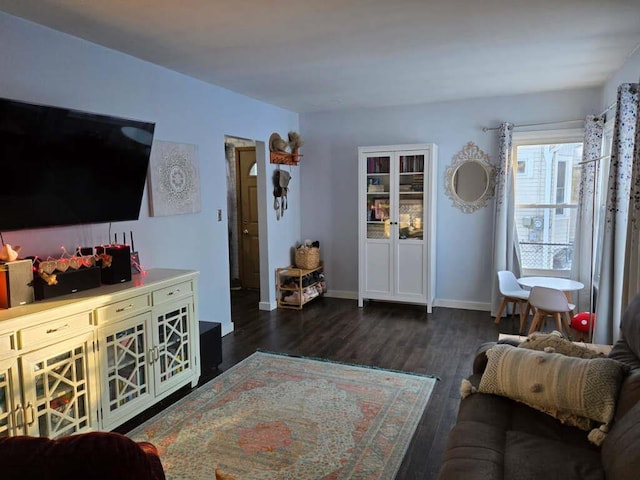 living room with dark wood-style flooring and baseboards