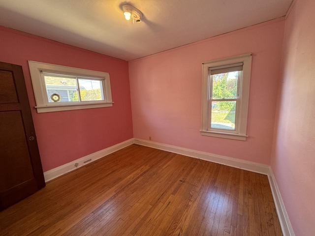 spare room with light wood finished floors and baseboards