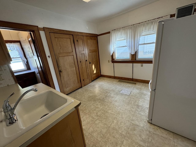 bathroom with visible vents, a sink, baseboards, and tile patterned floors