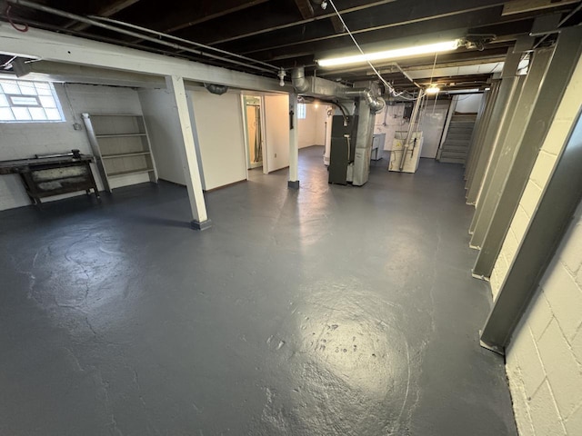 basement featuring heating unit and stairway