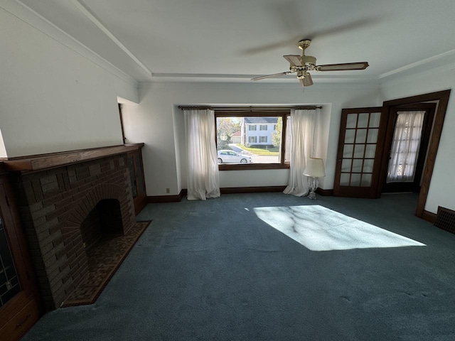 unfurnished living room featuring a fireplace, baseboards, dark carpet, and crown molding