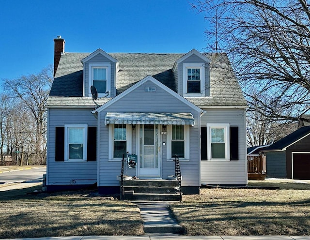 cape cod home with a front lawn and a chimney