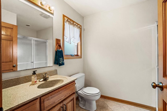 full bath with toilet, vanity, baseboards, a shower stall, and tile patterned floors