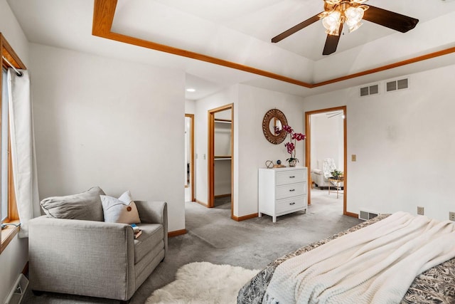 bedroom featuring a tray ceiling and visible vents